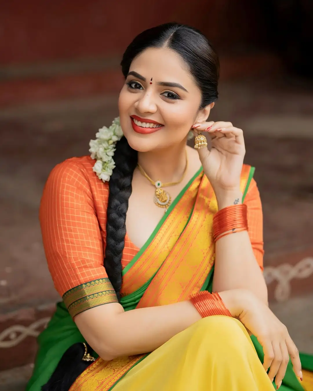 Sreemukhi Stills in Yellow Lehenga Orange Choli Green Voni